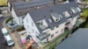 DIETZ: NEUBAU 3-Zimmer-Dachgeschosswohnung in Rodgau Rollwald! Terrasse, Tiefgaragenstellplatz - Luftbild  9-Familienhaus